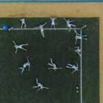 Players warming up on an artificial turf pitch.